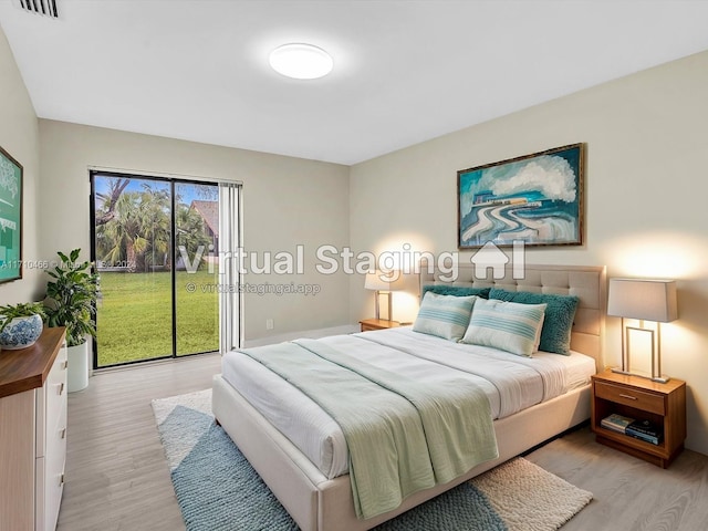 bedroom with light hardwood / wood-style floors and access to outside