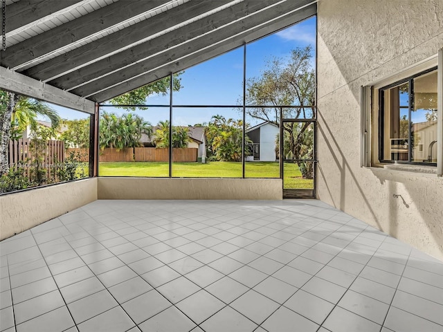 unfurnished sunroom with vaulted ceiling