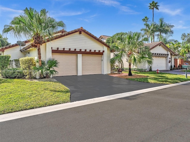 view of front of home featuring a garage and a front lawn