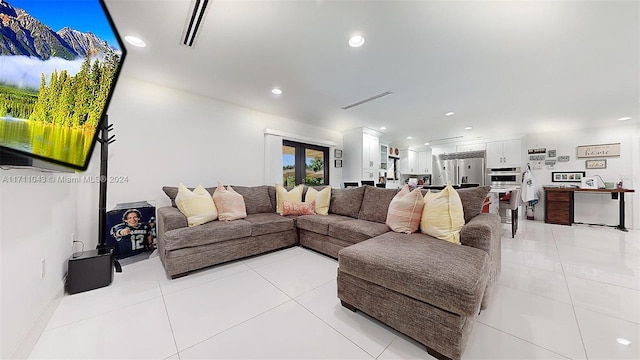 living room with light tile patterned floors and french doors