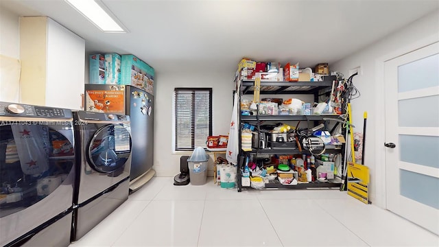 clothes washing area featuring separate washer and dryer and tile patterned floors