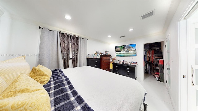 bedroom featuring tile patterned flooring, a closet, and crown molding