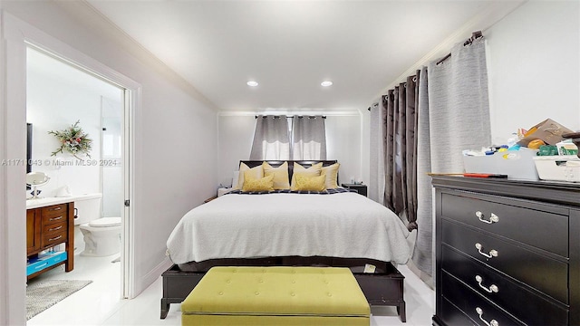 bedroom with ensuite bath and crown molding