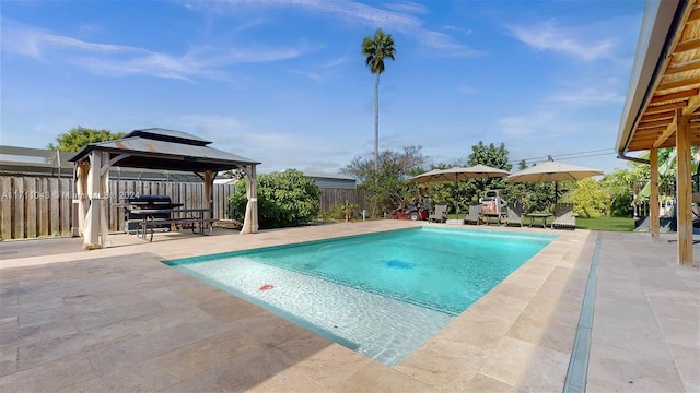 view of swimming pool with a gazebo, a patio area, and grilling area