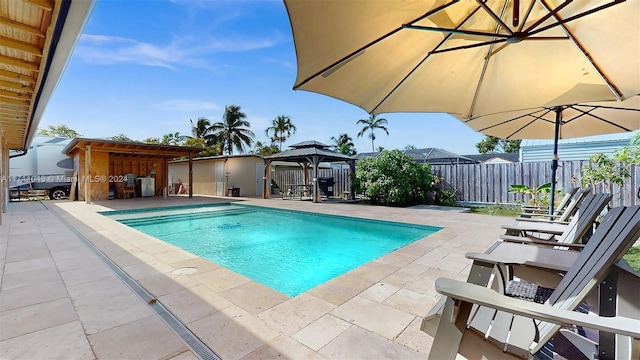 view of swimming pool with a gazebo and a patio area