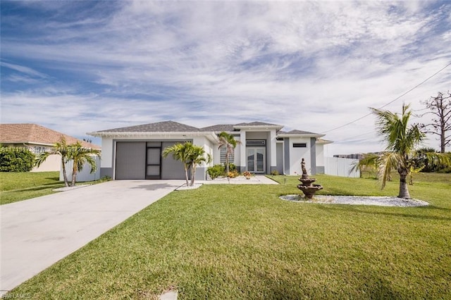 view of front of home with a garage and a front lawn