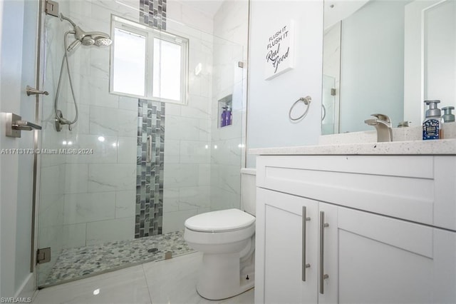 bathroom featuring vanity, toilet, and a shower with door