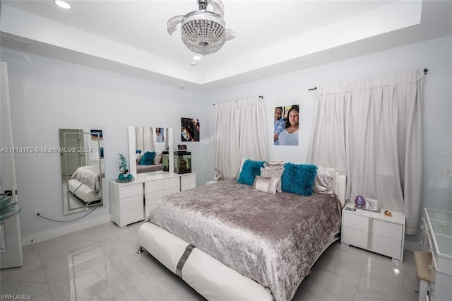 bedroom featuring a raised ceiling