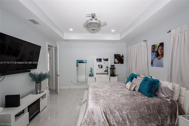 bedroom featuring a raised ceiling