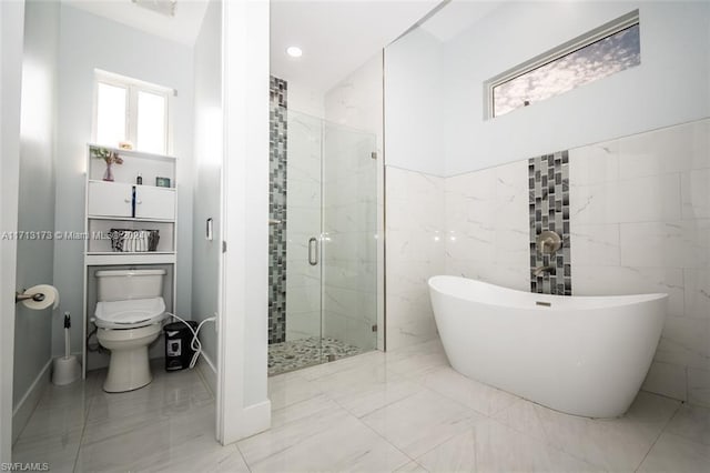 bathroom featuring shower with separate bathtub and toilet