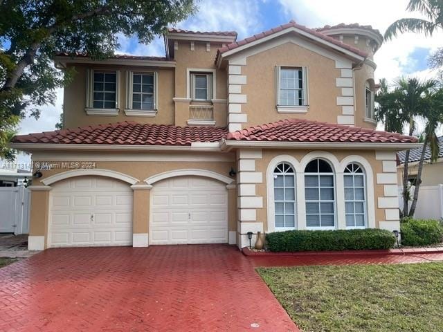 mediterranean / spanish house with a garage