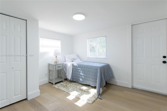 bedroom featuring two closets and light hardwood / wood-style flooring