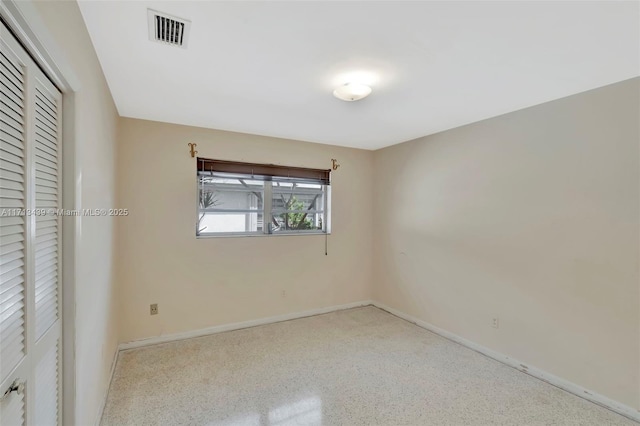 410 Miller Rd, Coral Gables, FL 33146 - unfurnished bedroom with baseboards, a closet, and speckled floor