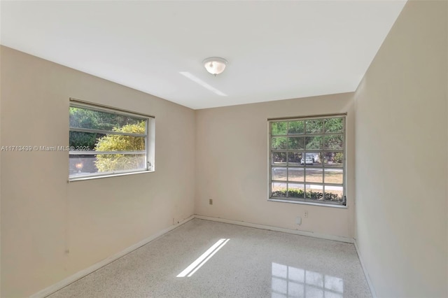 410 Miller Rd, Coral Gables, FL 33146 - empty room with healthy amount of natural light and baseboards