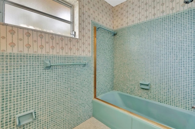 410 Miller Rd, Coral Gables, FL 33146 - full bathroom featuring wallpapered walls, tile walls, bath / shower combo with glass door, wainscoting, and tile patterned flooring