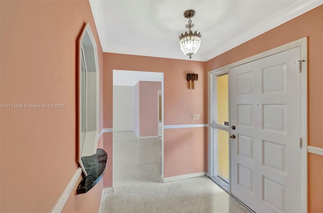 410 Miller Rd, Coral Gables, FL 33146 - entrance foyer featuring ornamental molding, speckled floor, and baseboards