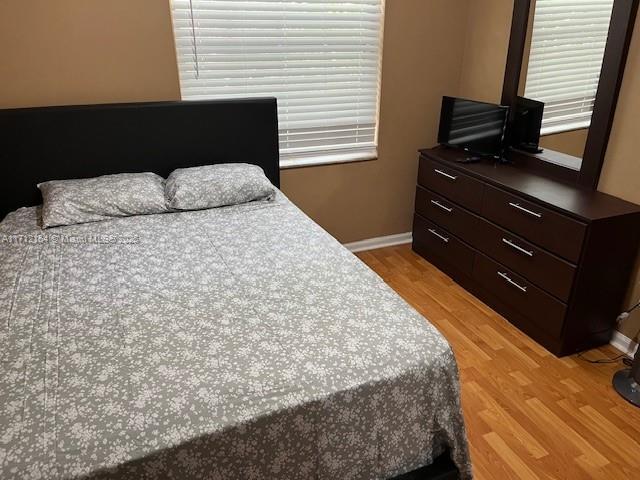 bedroom with light wood-type flooring