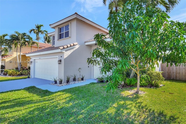 mediterranean / spanish home with a garage and a front lawn