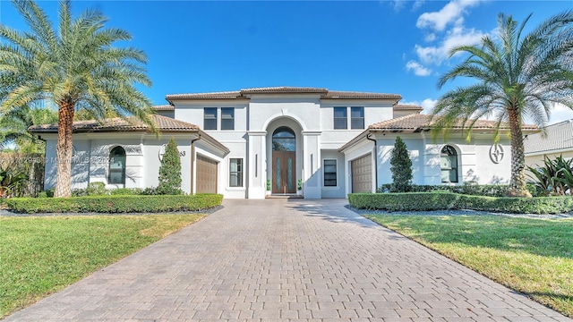 mediterranean / spanish home featuring a front yard