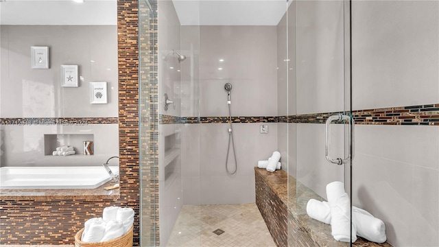 bathroom with tile walls and walk in shower