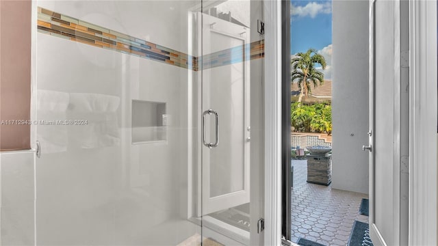 bathroom featuring a shower with door