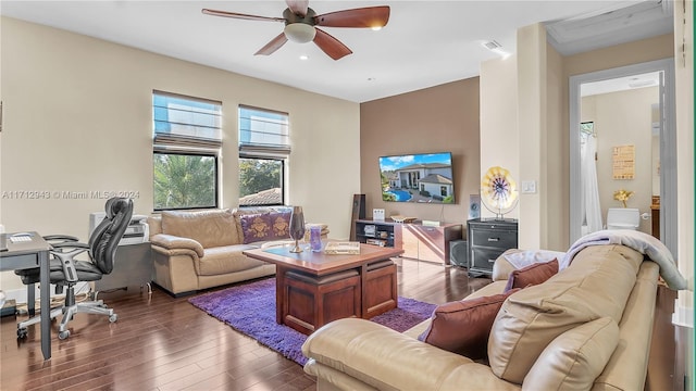 living room with ceiling fan and dark hardwood / wood-style flooring