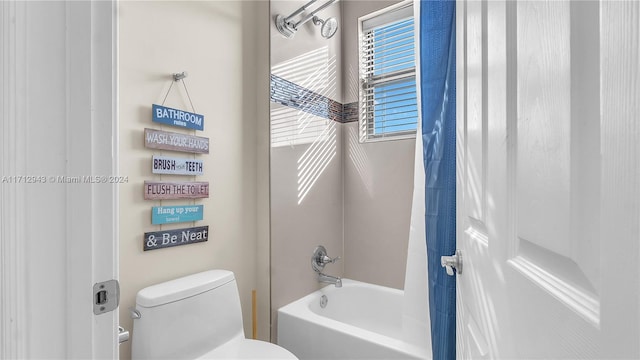 bathroom featuring shower / tub combo and toilet