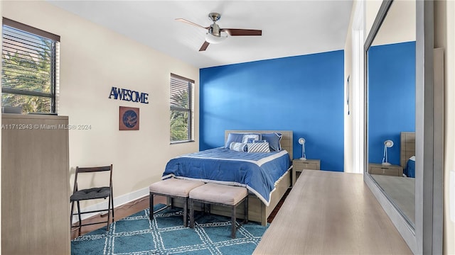 bedroom with hardwood / wood-style floors and ceiling fan