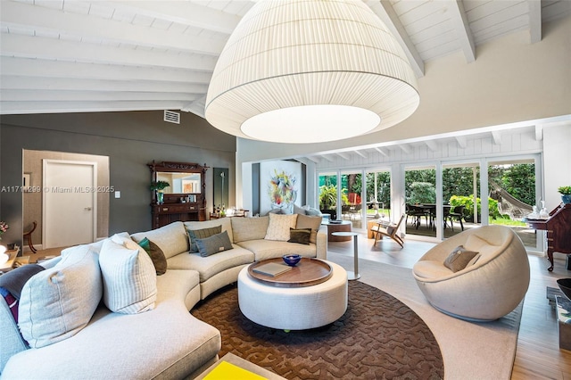 living room featuring vaulted ceiling with beams and wood-type flooring