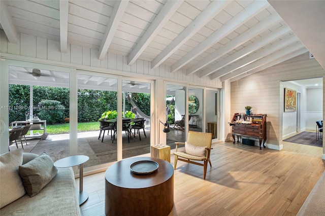 interior space with vaulted ceiling with beams and ceiling fan