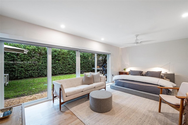 bedroom featuring access to exterior, light hardwood / wood-style flooring, and ceiling fan