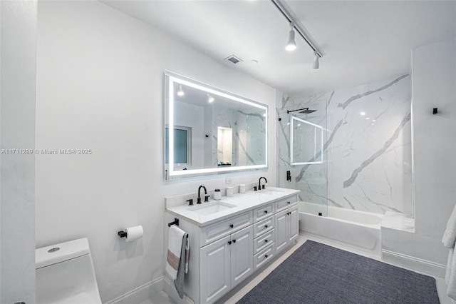 full bathroom with vanity, toilet, and tiled shower / bath