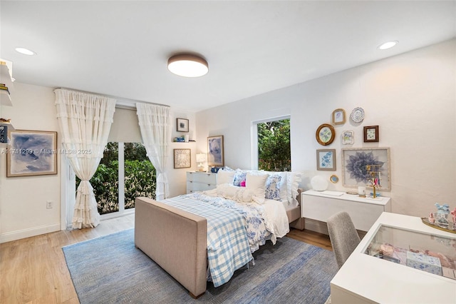 bedroom featuring access to outside and hardwood / wood-style flooring