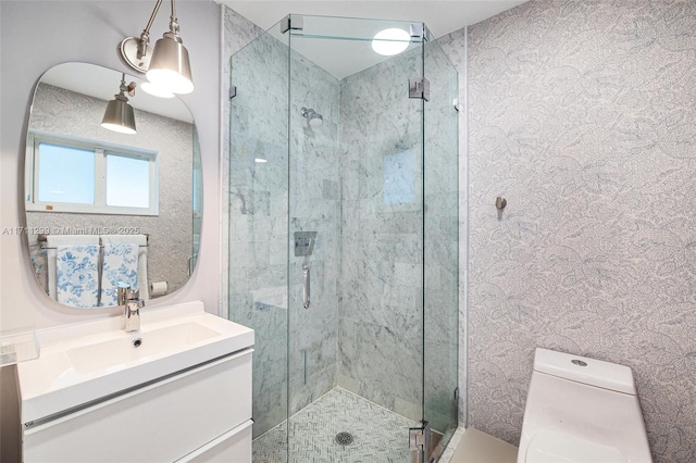 bathroom with vanity, a shower with shower door, and toilet