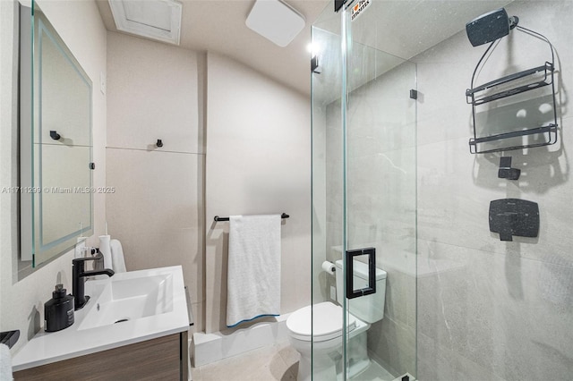 bathroom featuring vanity, toilet, and a shower with door