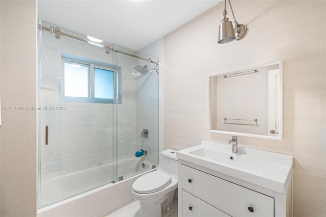 full bathroom featuring vanity, toilet, and bath / shower combo with glass door