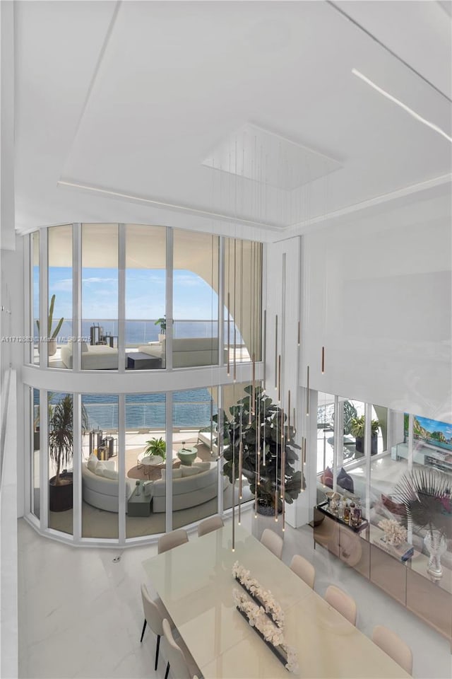 living room featuring a water view and floor to ceiling windows