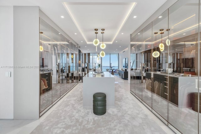 gym featuring expansive windows and a tray ceiling