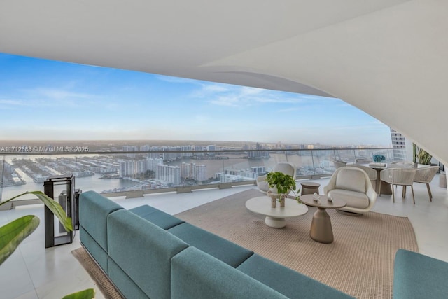 balcony with a water view and an outdoor hangout area