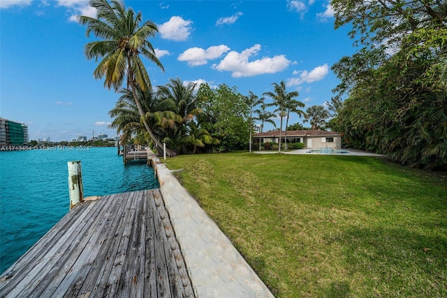 dock area with a water view and a lawn