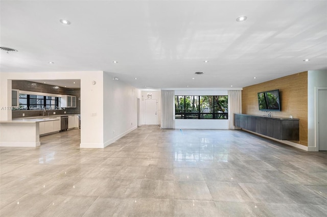 unfurnished living room with sink