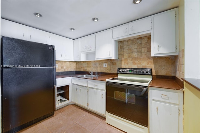 kitchen featuring white cabinetry, sink, white electric range oven, black refrigerator, and light tile patterned floors