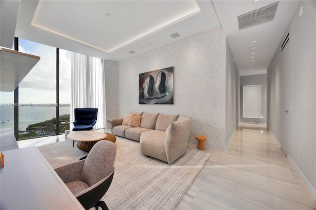 living room featuring expansive windows and a water view