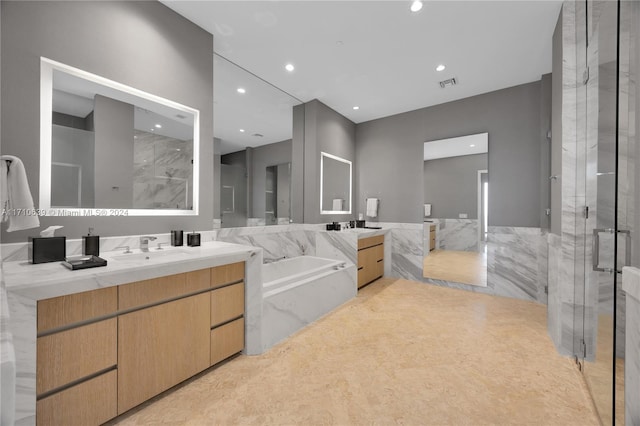 bathroom with vanity, separate shower and tub, and tile walls