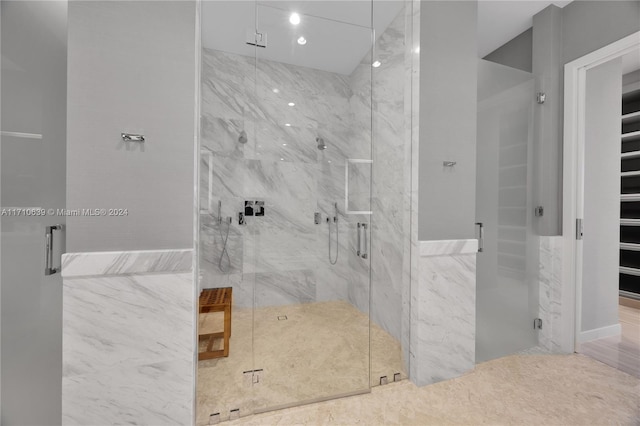 bathroom with tile walls and walk in shower