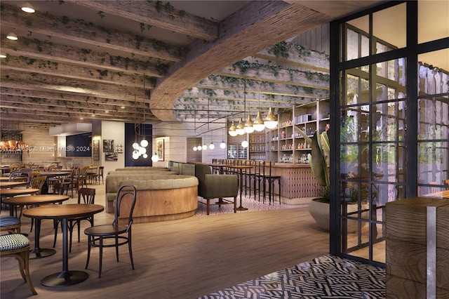 dining area with beamed ceiling, hardwood / wood-style floors, and indoor bar