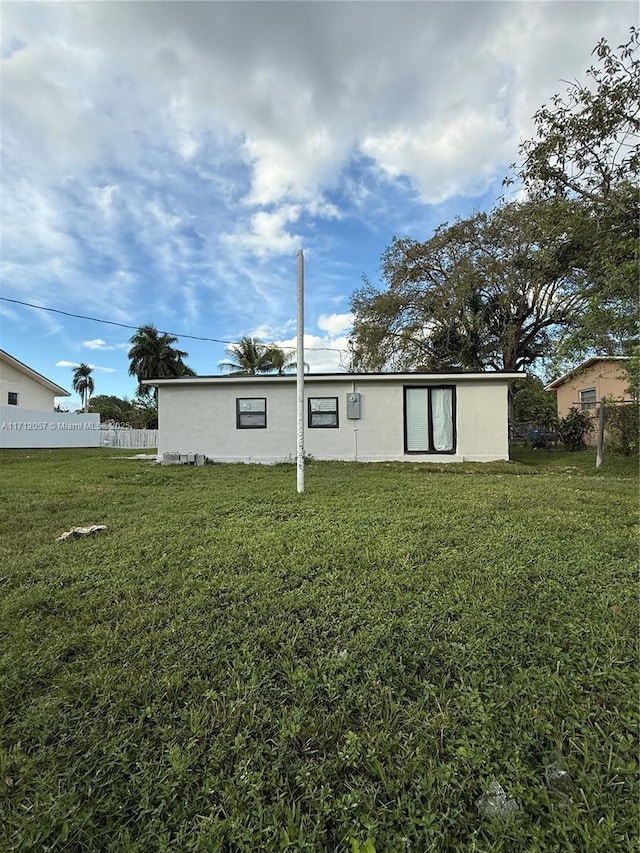 view of property exterior with a lawn