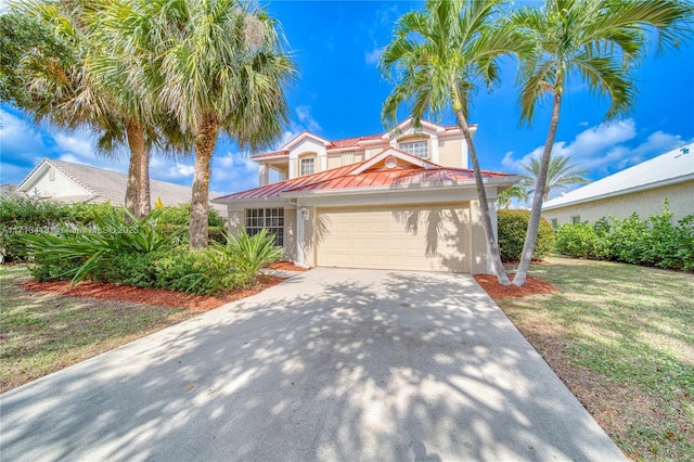 view of front of home featuring a front yard and a garage