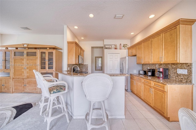 kitchen featuring light stone countertops, stainless steel appliances, and tasteful backsplash