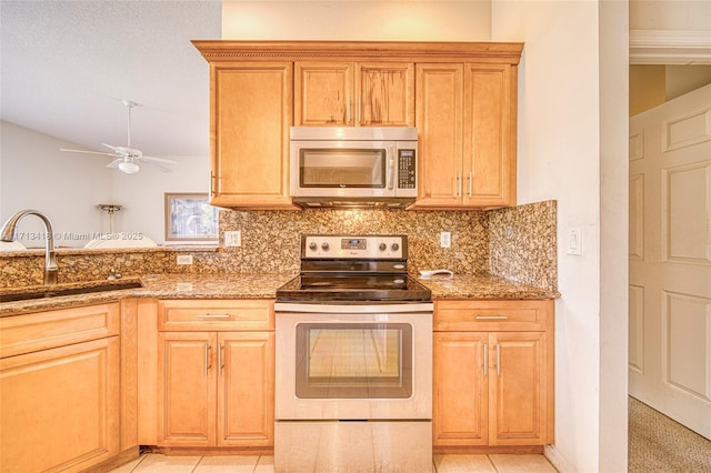 kitchen featuring light tile patterned flooring, sink, light stone counters, and electric stove